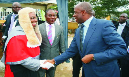 Governor Chibuike Rotimi Amaechi of Rivers State (right) being welcomed by Justice Peter Agumagu, President, Customary Court of Appeal, while Justice Iche Ndu, Chief Judge of Rivers State, watches, at the inauguration and dedication service of the Rivers State Customary Court of Appeal, in Port Harcourt, yesterday.