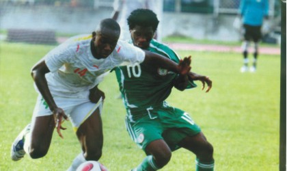 Nigerian youth player (10) in contest with a Malian opponent during a match.