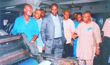 sept250903 Action Congress (AC) leader in Rivers State, Prince Tonye Princewill (centre) listening as General Manager, Rivers State Newspaper Corporation (RSNC) Mr Celestine Ogolo (right) explains difficulties of printing The Tide newspapers with obsolete machines, as the machine operator, Mr Micheal Menian (left), others watch.