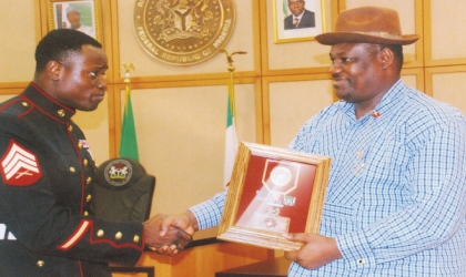 Rivers State Deputy Governor, Engr Tele Ikuru (right) receiving the US Purple Heart Award from Marine Sergeant (Dr)Ledum Ndaaee on behalf of Governor Chibuike Rotimi Amaechi at Government House, Port Harcourt, recently