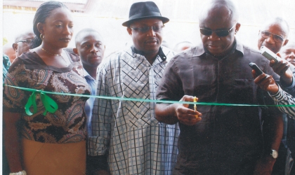 Dr Ibi Erekosima, a Consultant Physician (right) cutting the tape to commission a health facility at the former site of the UPTH , old Port Harcourt Township, assisted by the Rivers State Health Commissioner, Dr Sampson Parker  (centre), recently.