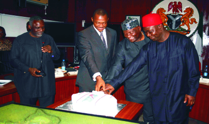 dec130902 Governor Sullivan Chime, Chief Nnia Nwodo and Deputy senate President, Senator Ike Ekweremadu, as the former Minister for Science and Technology, Prof. Bath Nnaji directs the cutting of Chief Nwodo's 57th birthday cake, during the 4th session of Enugu state elders council's meeting in Enugu....yesterday