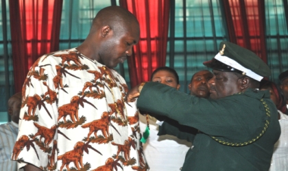 Representative of Rivers State Governor and Commissioner for Housing, Mr. Marshal Stanley Uwom being decorated by the State Chairman of the Legion, King (Col) Philemon Chinda Omunakwe (Rtd.) at the 2010 Armed Forces Remembrance Emblem Appeal Fund launch in Port Harcourt, yesterday.