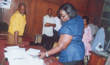 jan101002 Rivers State Commissioner for Information and Communication, Mrs Ibim Semenitari (standing centre) inspecting news items collections on the News Editor’s desk, Mr Thomas Abe, during the commissioner’s visit to the Rivers State Rivers State Newspaper Corporation, in Port Harcourt, last Friday. Photo: Chris Monyanaga