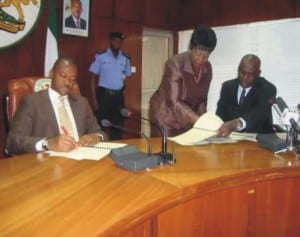 L-R: Governor Sullivan Chime, Clerk of the State House of Assembly, Barr. (Mrs.) Ijeoma V. Okereke with the Speaker of the House, Mr. Eugene Odo, while signing the 2010 appropriation bill, at the Government house, Enugu.