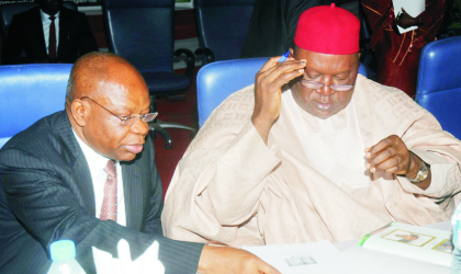 20031002 INEC Chairman, Prof. Maurice Iwu (left), with former Senate President, Chief Anyim Pius Anyim going through documents during INEC National Conference for stakeholders in Electoral Process in Abuja, last Wednesday.