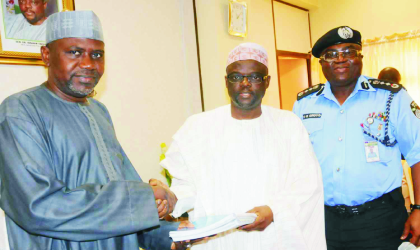 Inspector-General of Police, Mr Ogbonna Onovo (right) watching as the Permanent Secretary, Ministry of Police Affairs, Alhaji Bukar Goni-Aji (left) receives hand over note from out-going Minister of Police Affairs, Dr Ibrahim Lame, in Abuja, last Friday.