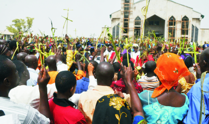 Catholic faithfuls raising their palm branches for blessing at St. Peter and Paul Parish, Nyanya, Abuja to mark 2010 Palm Sunday, yesterday