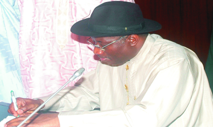 Acting President, Dr Goodluck Jonathan, signing the 2010 budget in Abuja on Thursday