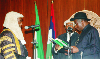 Acting President Goodluck Jonathan (right), taking his oath of office as the President of Nigeria before Chief Justice of the Federation,Justice Aloysius Katsina-Alu in Abuja, on Thursday.