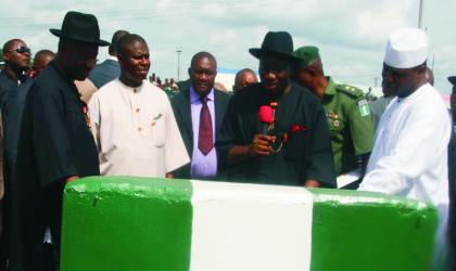 President Goodluck Jonathan (centre) supported by the Speaker, House of Representatives, Hon Demji Bankole (right), Rivers State Governor, Rt Hon Chibuike Rotimi Amaechi  (left) during the commissioning of Eleme junction flyover , Port Harcourt, last Friday. Photo: Chris Monyenaga