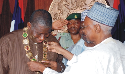 11061002 President Goodluck Jonathan (left) being decorated with the award of GCFR by former President, Alhaji Shehu Shagari in Abuja, last Tuesday .