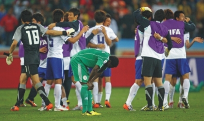 Super Eagles, Obafemi Martins bows in grief as South Korea celebrate , yesterday after their 2-2 draw in Group B