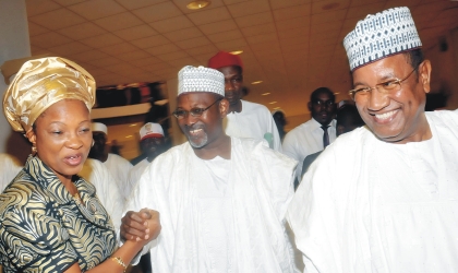FRED25061002 Independent National Electoral Commission (INEC), Commissioner, Mrs Gladys Nwafor (left) congratulating Prof Attahiru Jega, Chairman, INEC (middle), after his screening by the Senate in Abuja on Wednesday. With them is Special Adviser to the President on National Assembly Matters, Sen.Mohammed Abba Aji.