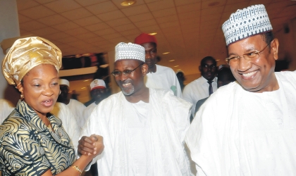 Independent National Electoral Commission (INEC), Commissioner, Mrs Gladys Nwafor (left) congratulating Prof Attahiru Jega, Chairman, INEC (middle), after his screening by the Senate in Abuja on Wednesday. With them is Special Adviser to the President on National  Assembly  Matters, Sen.Mohammed Abba Aji.