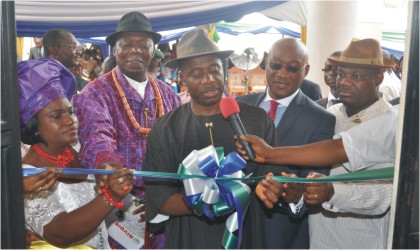 FRED201001 Rivers State Governor, Rt Hon Chibuike Amaechi cutting a tape to commission the Rivers State Geographic Information System (RIVGIS) in Port Harcourt, yesterday. He is flanked by the state Commissioner for Lands and Survey, Chief Ezemoye Ezekiel-Amadi (2nd right), HRM King Alfred Diete-Spiff, Amanyanabo of Twon Brass (2nd left), his Wife, Josephine and Engr. Tele Ikuru, Deputy Governor, of the State.