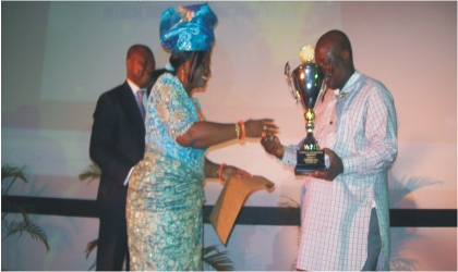 FRED291002 Mrs Josephine Diete-Spiff on behalf of her husband presenting the best performing local government trophy to Chairman, Gokana Local Government Area, Mr Victor Giadom at the Rivers State House of Assembly Auditorium, yesterday.