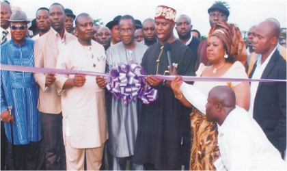 FRED051102 Governor of Rivers State, represented by state Commissioner for Works, Hon Dakuku Peterside (middle) being assisted by Deputy Speaker, Rivers State House of Assembly, Hon Dumnamene Deekor (3rd left) and Hon Maureen Tamuno, while cutting the tape during the commissioning of Tamuno’s constituency project in Ogu/Bolo LGA, on Tuesday.