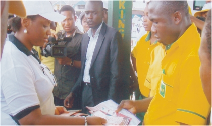 Wife of Rivers State Governor, Mrs Judith Amaechi (left) giving some pamphlets containing AIDS prevention to staff of AP Filling Station, Rumuokwuta, Port Harcourt during the celebration of 2010 World AIDS Day, on Monday. Photo: Nwiueh Donatus Ken
