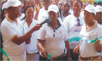 Wife of Rivers State Governor, Mrs Judith Amaechi (middle) cutting the tape to commission 37 health centres of the 606060 Projects embarked upon by the state government, while wife of Deputy Governor, Dr Mina T. Ikuru (right) and State Commissioner for Health, Dr Sampson Parker (left), watch, at Rumuepirikom in Obio/Akpor LGA, on Monday. Photo: Nwiuh Donatus Ken