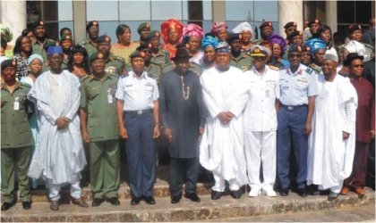 President Goodluck Jonathan(middle) in a group photograph with Service Chiefs, newly decorated army officers and their wives, in Abuja, yesterday.