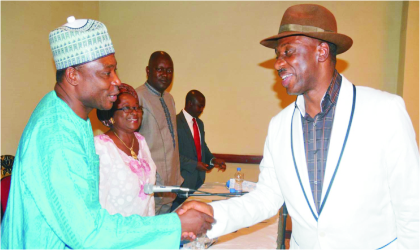 Rivers State Governor, Rt. Hon. Chibuike Ameachi (right) in a handshake with Deputy Director, News, Federal Radio Corporation of Nigeria (FRCN), Mr Mohammed Bello, during NUJ People’s Forum in Abuja, on Monday.
