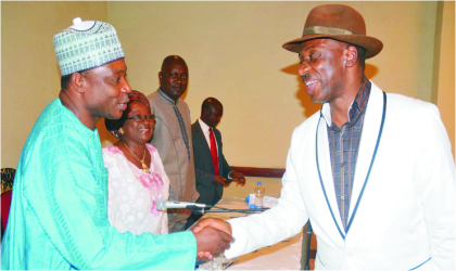 FRED05011101 Rivers State Governor, Rt. Hon. Chibuike Ameachi (right) in a handshake with Deputy Director, News, Federal Radio Corporation of Nigeria (FRCN), Mr Mohammed Bello, during NUJ People’s Forum in Abuja, on Monday.