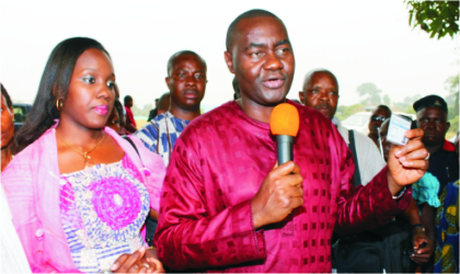 Former Secretary to the Rivers State Government, Hon Magnus Abe, with his wife, Bariyaa, displaying his voters card while addressing newsmen shortly after being registered in his ward in Gokana LGA at the weekend