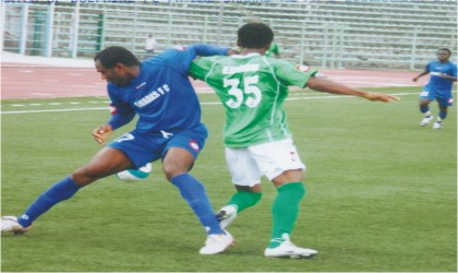 FRED26011103 Dolphins captain, ejindu (35) in a tussle with Shark's defender in a recent match.