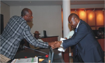 FRED28011101 Rivers State Governor, Rt. Hon. Chibuike Rotimi Amaechi (left) congratulating Dr Tekena Ibanibo after being sworn-in as Permanent Secretary in the State Civil Service at Government House, Port Harcourt, yesterday.