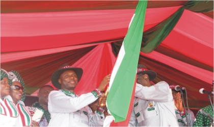 FRED14021101 Rivers State Governor, Rt. Hon. Chibuike Rotimi Amaechi (left) receiving the PDP flag from Dr Bello Halliru Mohammed, Acting National Chairman Of PDP as the governorship flag bearer for PDP in Rivers State at the South-South zone of presidential campaign held in Port Harcourt.