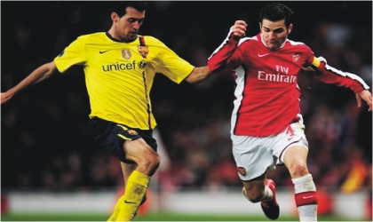 FRED16021103 Arsenal’s Cesc Fabregas (right) and Sergio Busquets of Barcelona. Both are expected to clash in midfield today