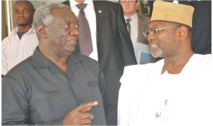 FRED04031103 Former Ghanaian President, Mr John Kuffour (left), discussing with Chairman, Prof. Attahiru Jega, Independent National Electoral Commission, during his visit to INEC office in Abuja, yesterday