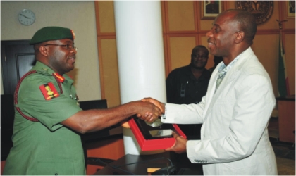 FRED09031101 Rivers State Governor, Rt Hon Chibuike Rotimi Amaechi (right) receiving a souvenir from Lt Gen Onyeabo Azubuike Ihejirika, Chief of Army Staff ,during a courtesy visit to Government House, Port Harcourt, yesterday.