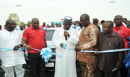 Nigeria Football Federation (NFF) President, Alhaji Maigari Aminu (centre) cutting the tape to commission the cars donated by Governor Chibuike Amaechi to Sharks Football Club of Port Harcourt for winning the 2010 WAFU Cup. He is supported by Commissioner for Sports, Hon Boma Iyaye (2nd left), Chairman Technical sub Committee of the NFA,  Mr Christopher Green,  Permanent Secretary SSG's office, Mr Solvins Okari and Permanent Secretary Ministry of Sports, Mr Walter Ndu, at the Sharks Stadium, Port Harcourt, yesterday.
