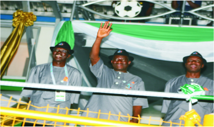 FRED04071103 President Goodluck Jonathan acknowledging cheers during the parade by participating states at the Garden City Games, yesterday. He is flanked byRivers State Governor, Rt Hon Rotimi Amaechi (right) and the Director-General, National Sports Commission, Chief Patrick Ekeji. Photo: Chris Monyanaga