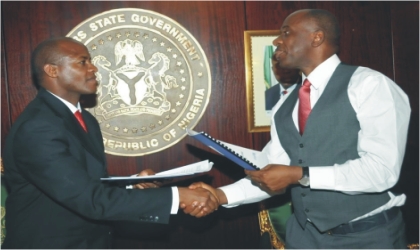 FRED06071101 Rivers State Governor, Rt Hon Chibuike Amaechi (right) exchanging the Programme Implementation Agreement with Mr Charles Nzuki of UNICEF at Government House Port Harcourt.