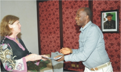 FRED15071101 Rivers State Governor, Rt Hon Chibuike Amaechi receiving an address from team leader Violaine Mitchel of Bill and Melinda Gates Foundation, USA, on behalf of Global Alliance on Vaccines and Immunisation (GAVI), during a courtesy visit to Government House, Port Harcourt, yesterday.