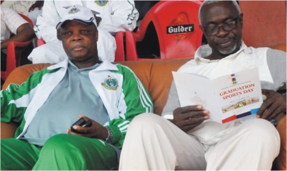 Commandant, National Defence College, (NDC) Rear Adm. Thomas Lokoson (l) with the representative of FCT Minister, Alhaji Mohammed Musa at the graduation sports day of the NDC Course 19 in Abuja, on Saturday