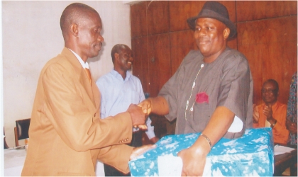 FRED15081102 Chief Dagogo Clinton, Director of Production, Rivers state Newspaper Corporation (right) presenting a gift to Mr Peter Waate, former Director of Finance, during the sendforth party organised by staff of the Account Department last Wednesdy. Photo: Nwieueh Donatus Ken