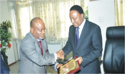 Secretary to Rivers State Government, Mr George Feyii (right) receiving a plaque from Dr Samuel Amaechi, during a courtesy visit to his office in Port Harcourt.