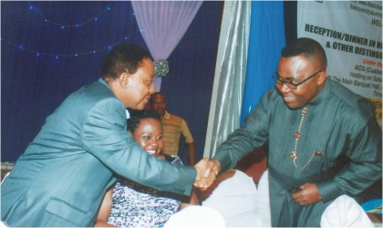 Secretary to Rivers State Government, Mr George Feyii (left) in a handshake with  the Commissioner for Finance, Dr Chamberlain Peterside at the reception organised for distinguished members of the Government Secondary and Commercial College, Ibaa, at Hotel Presidential, Port Harcourt, last Saturday. Photo; Chris Monyanaga