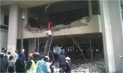 Rescue workers at the UN building rescuing victims of the bomb blast in Abuja, last Friday.