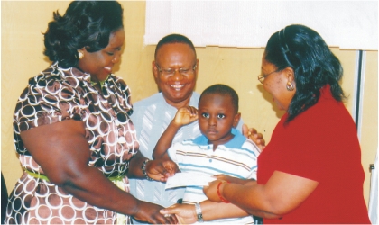 FRED14091101 Mrs Ibim Semenitari,Rivers State Commissioner for Information and Communications (left), presenting a cheque to Master Taiwo Amina, a patient of University of Port Harcourt Teaching Hospital (UPTH) while Dr Christie Mato, Chairman, Medical Advisory Committee and Mr John Nally, Permanent Secretary in the ministry watch, yesterday.