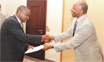 Rivers State Governor, Rt. Hon. Chibuike Amaechi (right), receiving  a paper from President of  Petroleum and Natural Gas Senior Staff Association of Nigeria (PENGASSAN), Comrade Babatunde Ogun, during a courtesy visit in Government House, Port Harcourt, Monday.