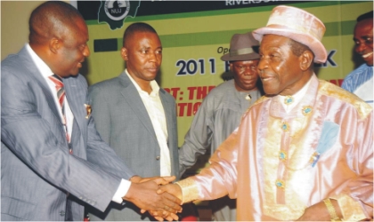 Former Chairman, Nigeria Union of Journalists, Rivers State Council, Mr Ipalibo Karibi-Botoye (left) in a handshake with Amanyanabo of Kalabari Kingdom, Prof. J. T. J. Princewill,  during the 2011 Rivers NUJ Press Week in Port Harcourt, on Monday. With them is Deputy Speaker, State House of Assembly, Mr Leyii Kwane (2nd left) and Chief Emma Anyanwu.
