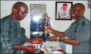 Chairman, Correspondents' Chapel, Abia State NUJ, Mr Peter Okorie (left), presenting a football trophy won during the recent NUJ Media Games by the Chapel to the Chief Press Secretary to the Governor of Abia, Mr Ugochukwu Emezue in Umuahia, recently.