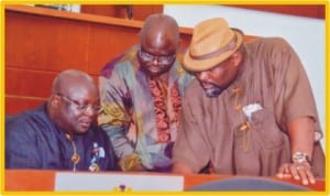 Speaker, Rivers State House of Assembly, Rt. Hon. Otelemaba Amachree (left), former Speaker, Rt. Hon Tonye Harry (middle) and Leder of the House, Hon. Chidi Lloyd, scrutinising the 2013 Appropriation Bill prior to its passage, recently. Photo: Chris Monyanaga