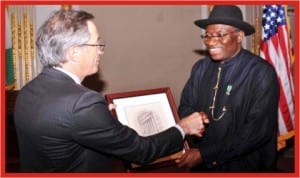 Chief Executive Officer, New York Stock Exchange, Mr Larry Leibowitz (left), presenting a souvenir to President Goodluck Jonathan, during the President's visit to New York  Stock Exchange in New York last Monday.