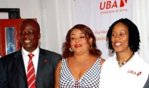 L-R: United Bank for Africa (UBA) Director of Consumer Banking, Mr Ilesanmi Owoeye, a customer, Ms Gladys Ugwuagu and Uba Head, Retail Products Division, Mrs Olumide Osunyomi during UBA launch of U-Gold Banking Product in Enugu, last week. Photo: NAN